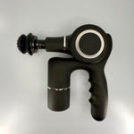 Black massage gun on a light gray background