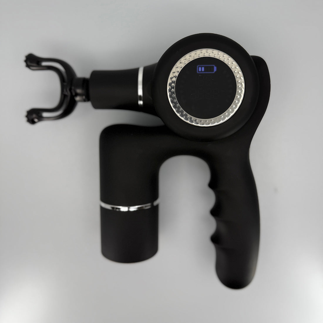 Black handheld massage gun on a light gray background